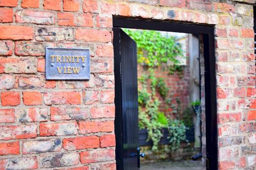 a brick wall with a sign that reads trinity view at Trinity View YORK in York