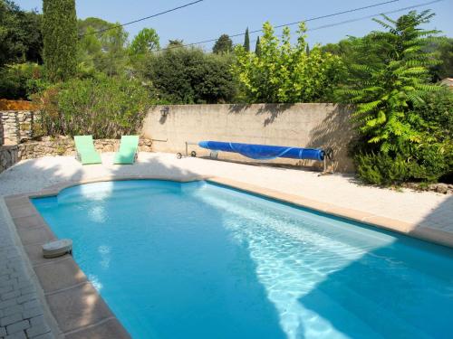 a swimming pool with two lawn chairs and a swimming pool at Holiday Home Le Paouvadon by Interhome in La Motte