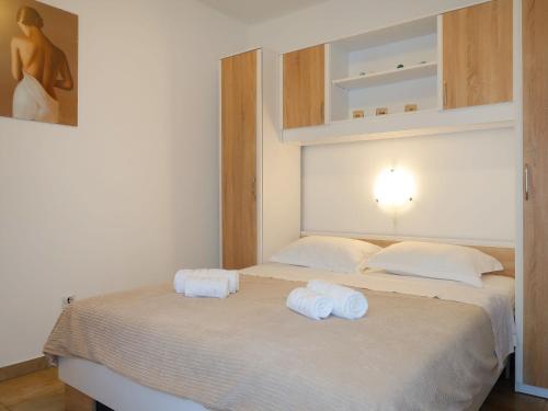 a bedroom with two white towels on a bed at Apartment Meri - KRK211 by Interhome in Kornić