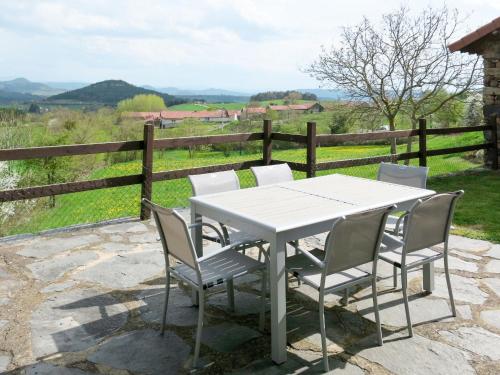 a white table and chairs with a view of a field at Holiday Home Le Chomeil by Interhome in Chamalières-sur-Loire