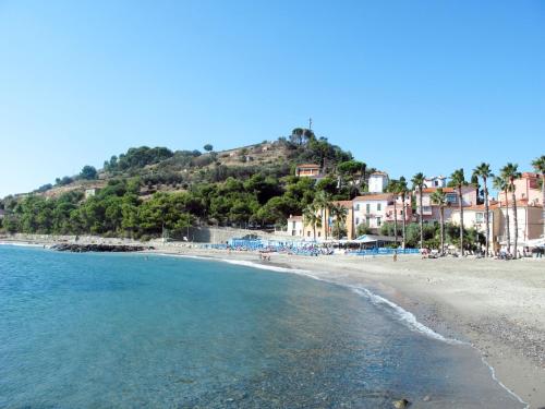 a view of a beach with houses on a hill at Apartment Roma - SLR219 by Interhome in Cipressa