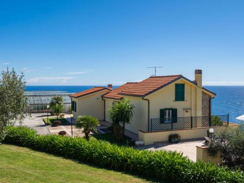 a house with the ocean in the background at Apartment Primavera - PGI132 by Interhome in Poggi