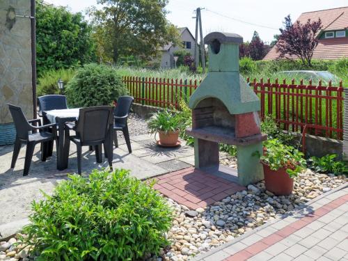 a outdoor oven in a garden with a table and chairs at Holiday Home Rakoczi - MAF139 by Interhome in Balatonmáriafürdő