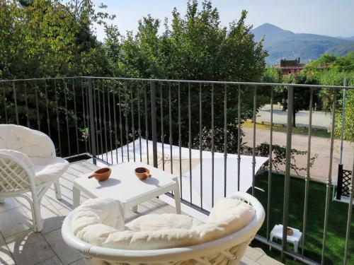 a patio with two chairs and a table on a balcony at Holiday Home Anna by Interhome in Luino