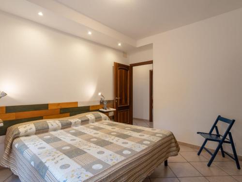 a bedroom with a bed and a chair in it at Holiday Home Innovativa by Interhome in Stellanello