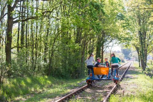 a group of people riding on a small train at Maison de campagne pour 6 in Commequiers