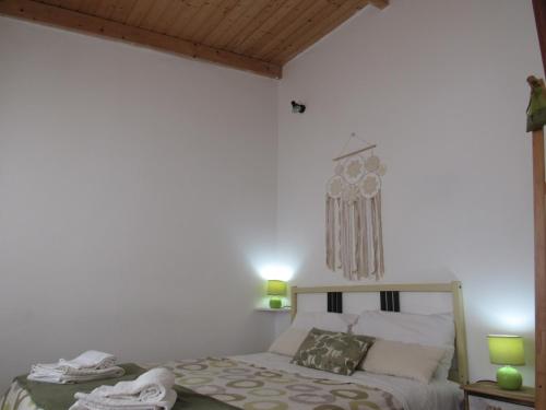 a bedroom with a bed and a chandelier at Casa O Cantinho Algarvio in Odeceixe