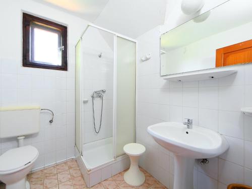 a bathroom with a toilet sink and a shower at Holiday Home Sunlight by Interhome in Balatonőszöd