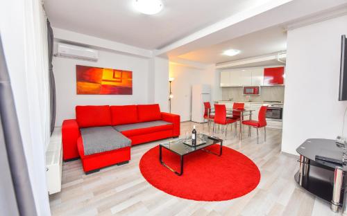 a living room with a red couch and a red rug at Bucharest Accommodation Apartments in Bucharest