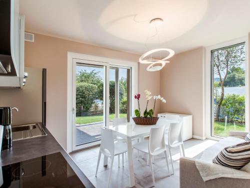 a kitchen and dining room with a white table and chairs at Apartment Iris e Girasole by Interhome in Manerba del Garda