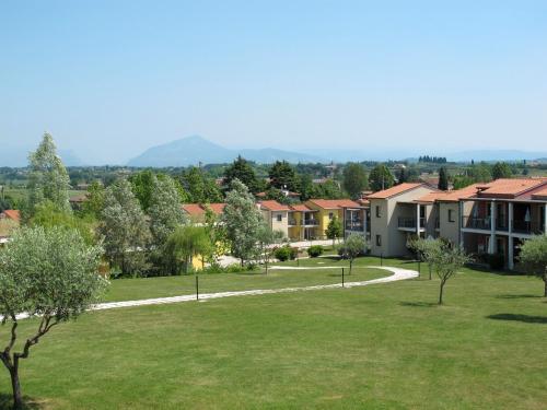 a view of a park with houses at Apartment Belvedere Village-2 by Interhome in Cavalcaselle