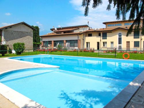 a large swimming pool in front of a building at Apartment Colombaro Nuovo-5 by Interhome in San Felice del Benaco
