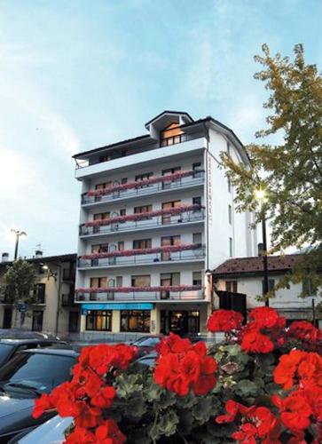 a large building with red flowers in front of it at Residence Saint-Vincent in Saint Vincent