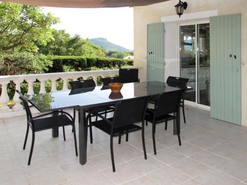 einen Esstisch und Stühle auf einer Terrasse in der Unterkunft Holiday Home L'Yeuse - BEF160 by Interhome in Plan Florent