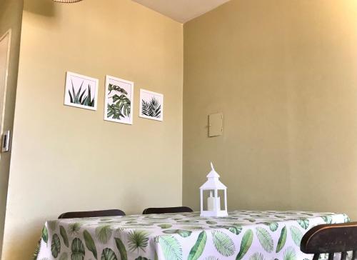 a dining room with a table and three pictures on the wall at Departamento Sarmiento in Rosario