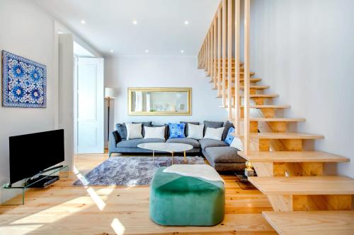 a living room with a couch and a staircase at Life is Good in Lisbon Baixa in Lisbon