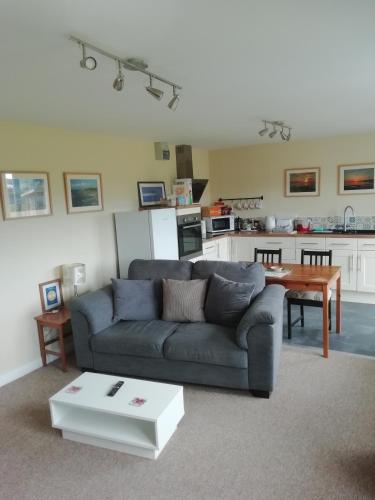 a living room with a couch and a table at The Studio in Georgeham
