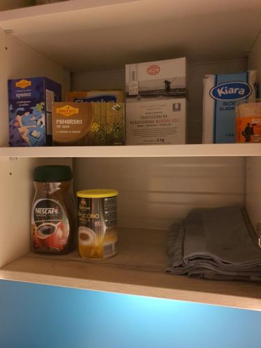 a shelf with food and other items on it at Roof Apartment ART-PE in Trebnje