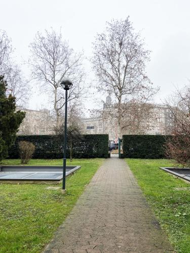 a park with a light pole in the grass at Casa di Laura mono e bilo di fronte Ospedale San Raffaele in Segrate