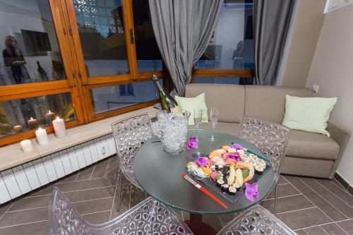 a table and chairs with a plate of food on it at HH Hermoso Housing ALESSANDRIA in Alessandria