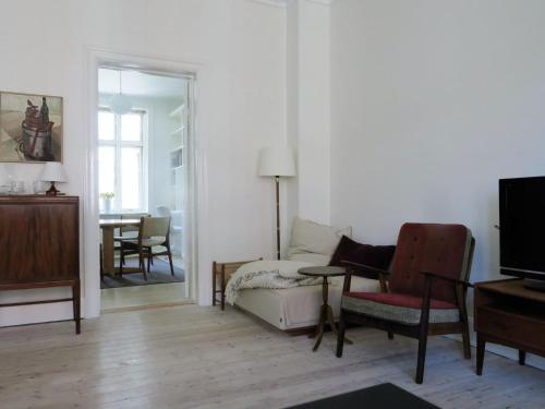 ein Wohnzimmer mit einer Couch und einem Sessel in der Unterkunft ApartmentInCopenhagen Apartment 1382 in Kopenhagen