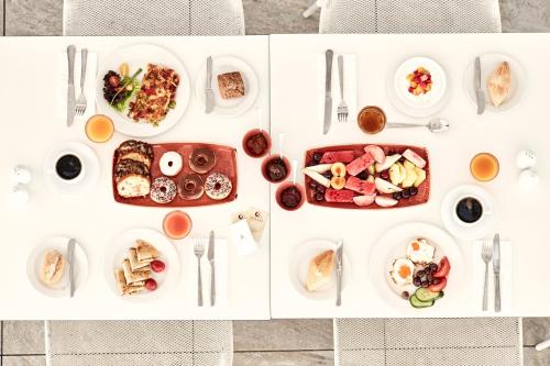 een witte tafel met borden voedsel erop bij Atlantica Aeneas Resort in Ayia Napa