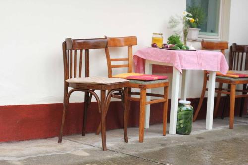 uma mesa com duas cadeiras e uma mesa com uma toalha de mesa rosa em Balla Mama, Hajdúszoboszló em Hajdúszoboszló