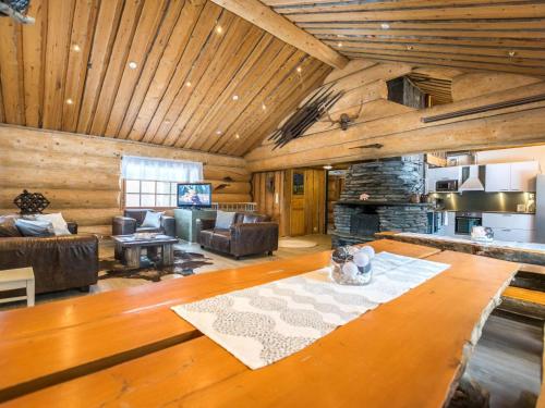 a large living room with wooden ceilings and a fireplace at Holiday Home Juurakkopirtti by Interhome in Keuruu