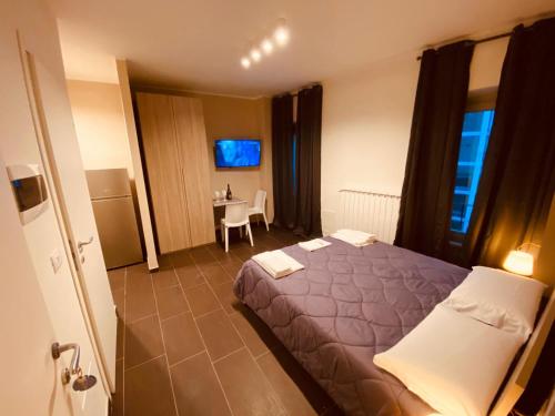 a hotel room with a bed and a table at HH Hermoso Housing VALENZA in Valenza