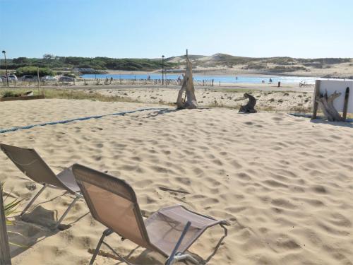 a couple of chairs sitting on a sandy beach at Holiday Home Les Baïnes - VIB220 by Interhome in Vieux-Boucau-les-Bains