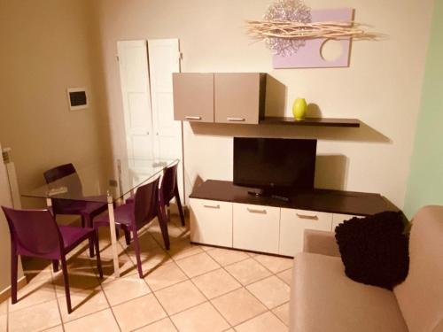 a living room with a table and a dining room at HH Hermoso Housing VALENZA in Valenza