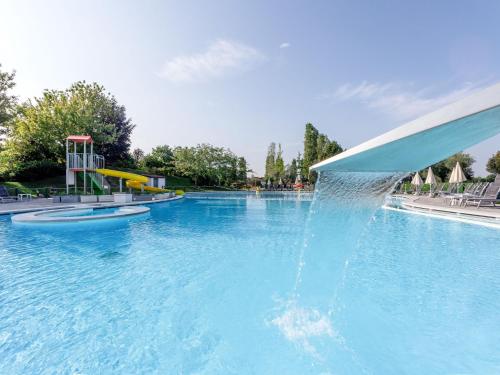 a water fountain in a swimming pool at Apartment Eden by Interhome in Cavalcaselle