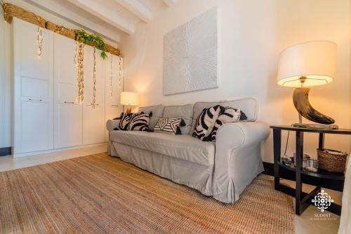 a living room with a couch and a table at Casa Ramal - Tipica dimora Siciliana in Siracusa