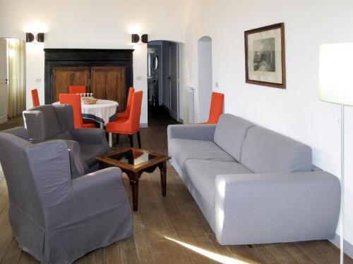 een woonkamer met een bank, stoelen en een tafel bij Apartment Camelot - FLG204 by Interhome in Finale Ligure