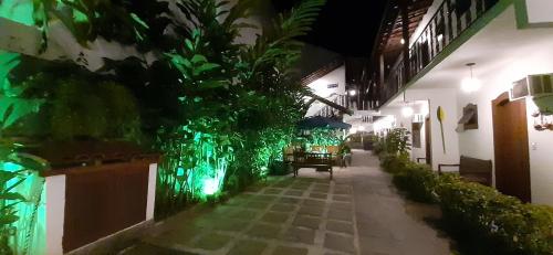 a walkway in a building at night with green lights at Pousada Doce Paraty in Paraty