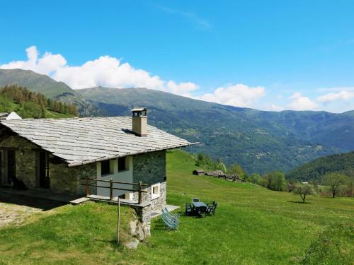 a house on a hill with mountains in the background at Chalet Casot Pra La Funt by Interhome in Sampeire