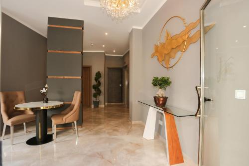 a dining room with a table and chairs and a chandelier at J'Me Boutique Hotel - Adults only in St Julian's