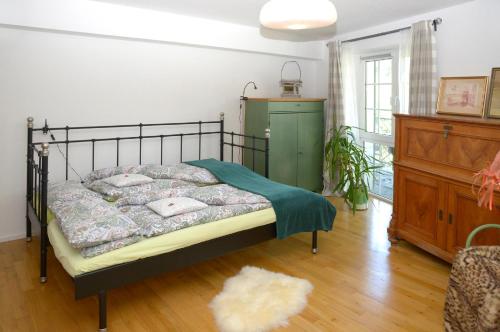 a bedroom with a bed with a green dresser at Casa Christallina in Overath