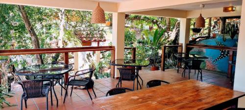 a patio with tables and chairs in a restaurant at Hotel Iguanito in Santa Catalina