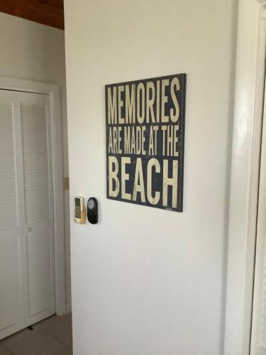 a sign is hanging on a wall in a room at Tropical View Villas in Hartswell