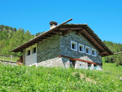 a stone house on a hill in a field at Chalet Casot Brusa - SMY101 by Interhome in Sampeire