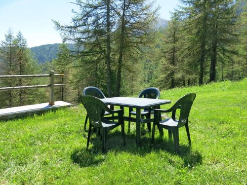 a table and chairs in a field of grass at Chalet Casot Brusa - SMY101 by Interhome in Sampeyre
