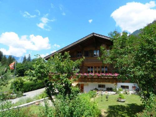 a house with a garden in front of it at Apartment Giferblick by Interhome in Zweisimmen