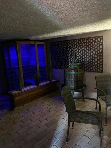 a room with chairs and a table and windows at Rubin in Doba