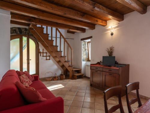 a living room with a red couch and a tv at Holiday Home I Ciasi - VSP200 by Interhome in Ville San Sebastiano