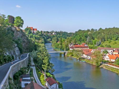 a view of a river with a bridge and buildings at Holiday Home Parkany 2 by Interhome in Bechyně