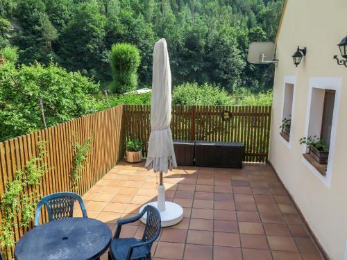 a patio with an umbrella and a table and chairs at Holiday Home Parkany 2 by Interhome in Bechyně
