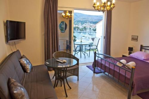 a living room with a couch and a table at Apartment in Trogir with sea view, terrace, air conditioning, Wi-Fi (3788-2) in Trogir