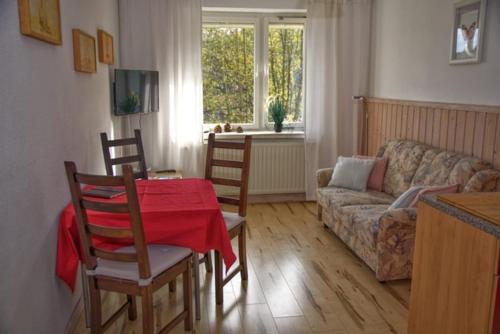 a living room with a table and a couch at Ferienwohnung Wolf in Gräfenroda