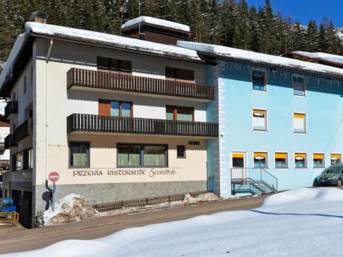 a blue and white building with snow in front of it at Apartment Apt 3 by Interhome in Canazei